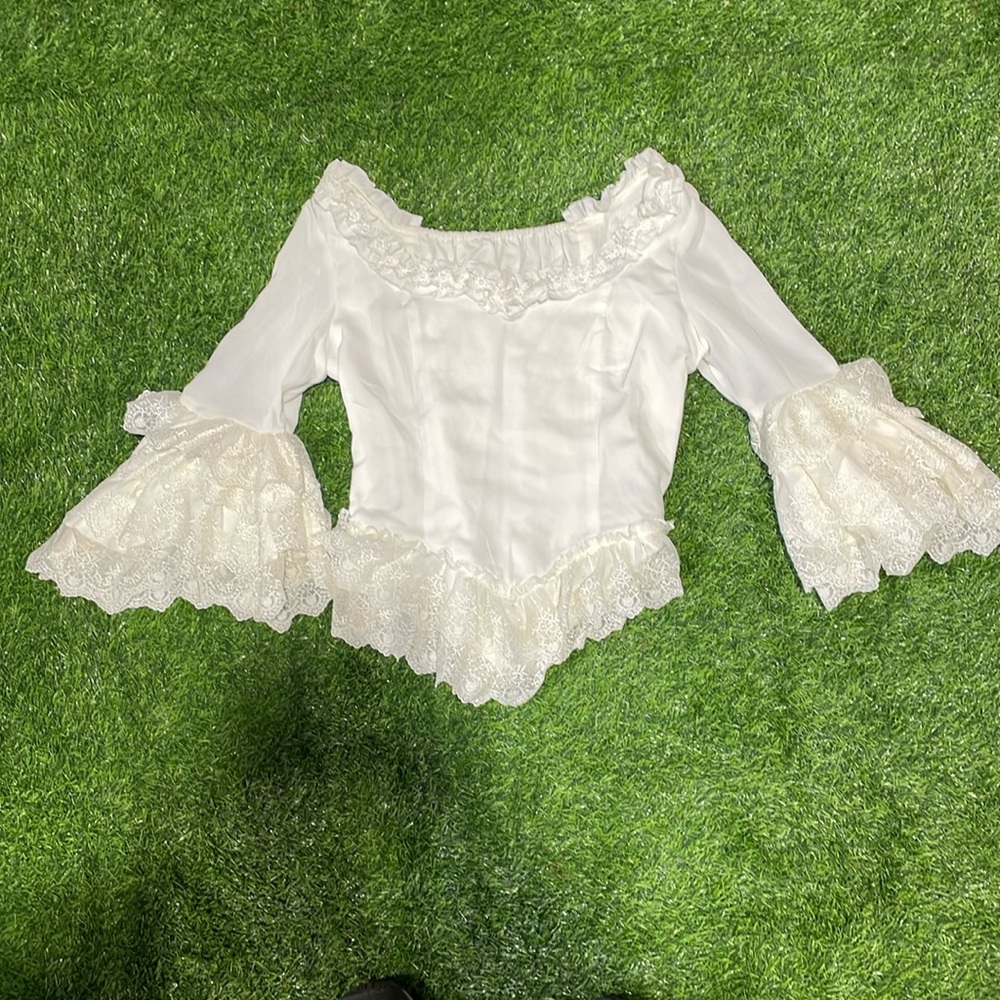 Ladies white Victorian style blouse with cream lace trim.